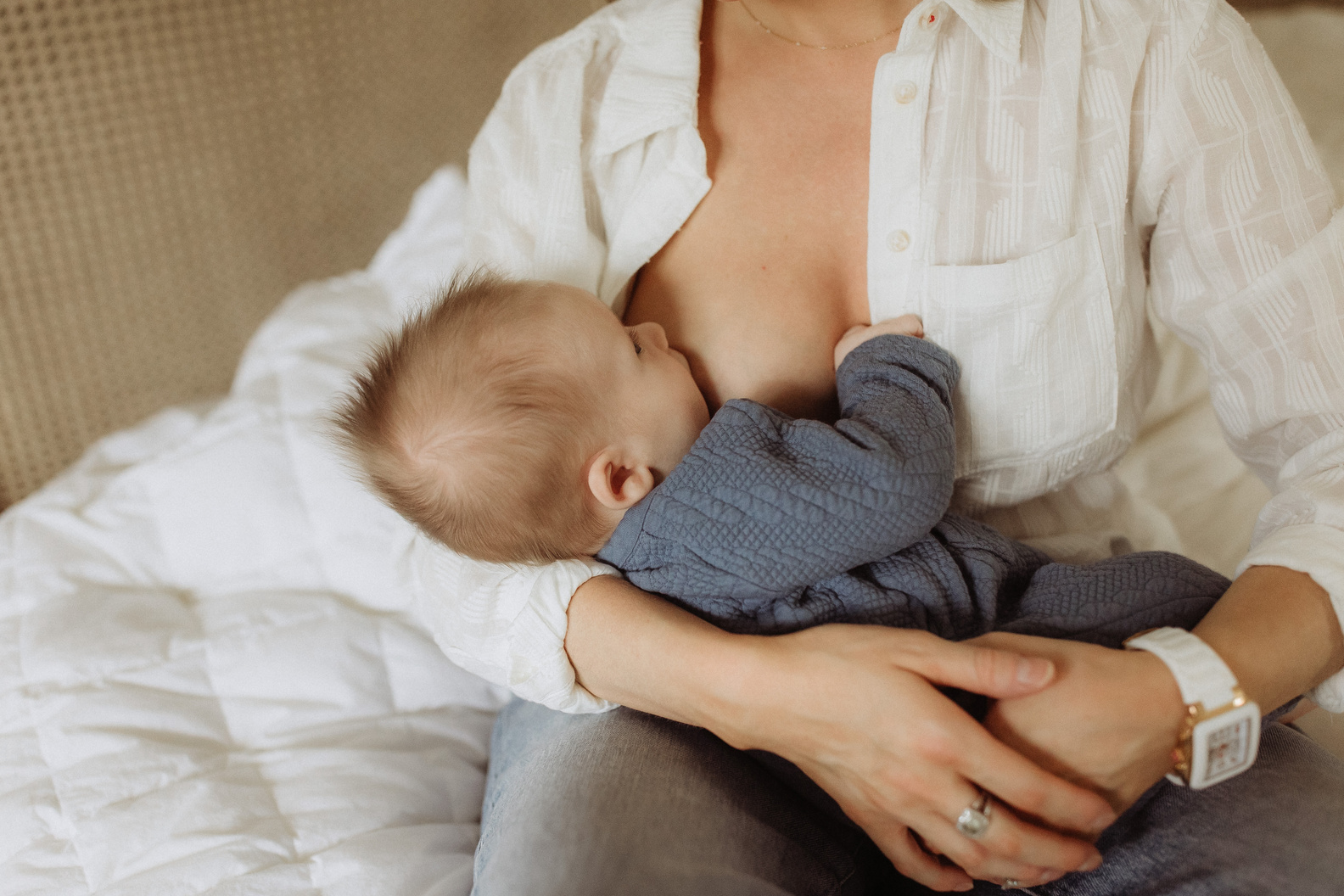 Mother Breastfeeding Son in Bed